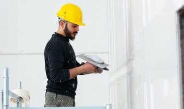 Plasterer skimming a wall to a smooth finish