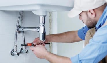 Plumber working on copper pipework during a property repair