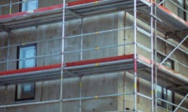 Scaffolding erected against a building for safe working access